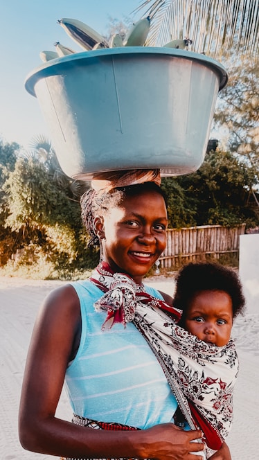 A woman carrying a child on her back