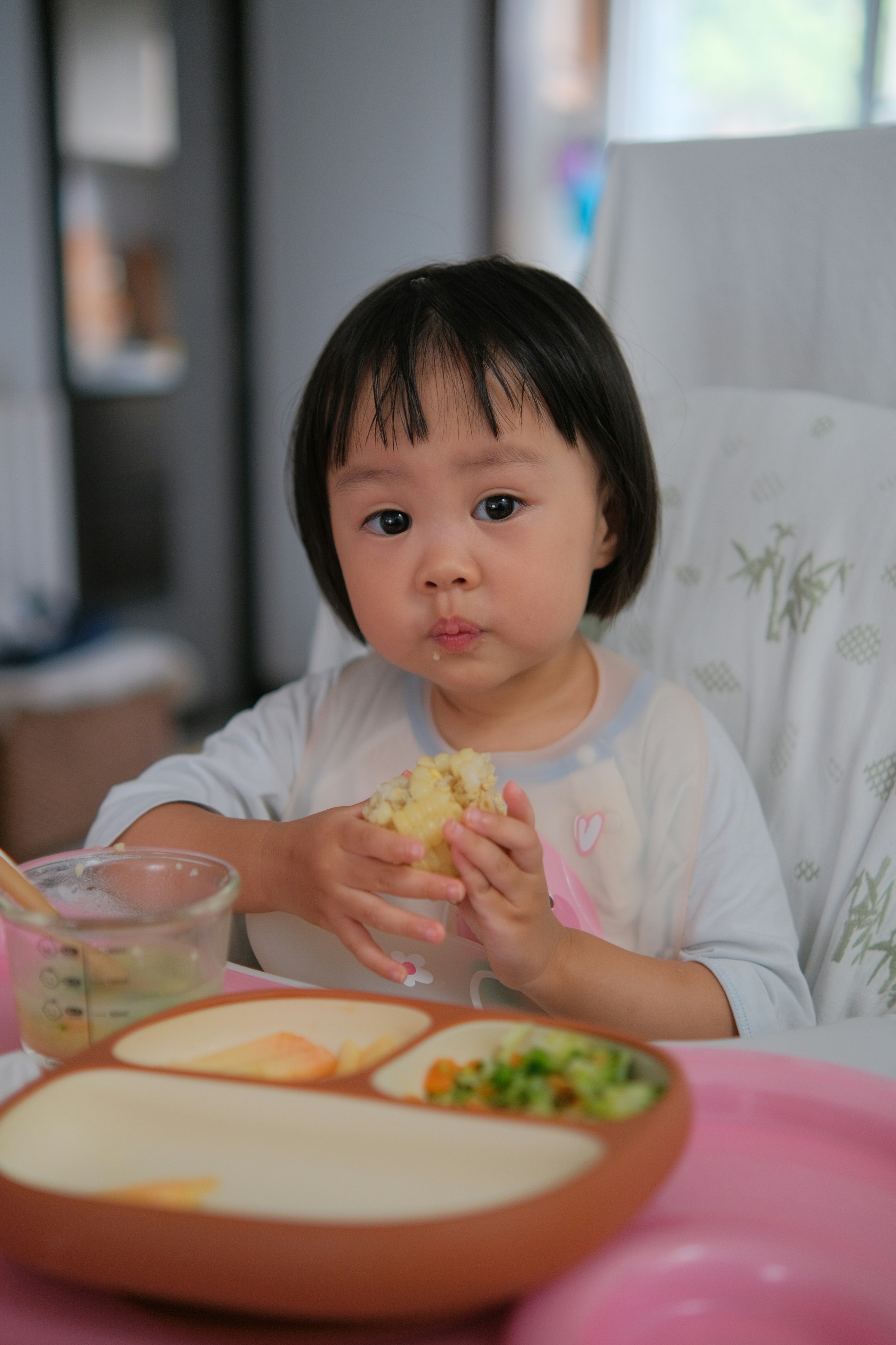 A child enjoying a nutritious breakfast with fruit and cereals