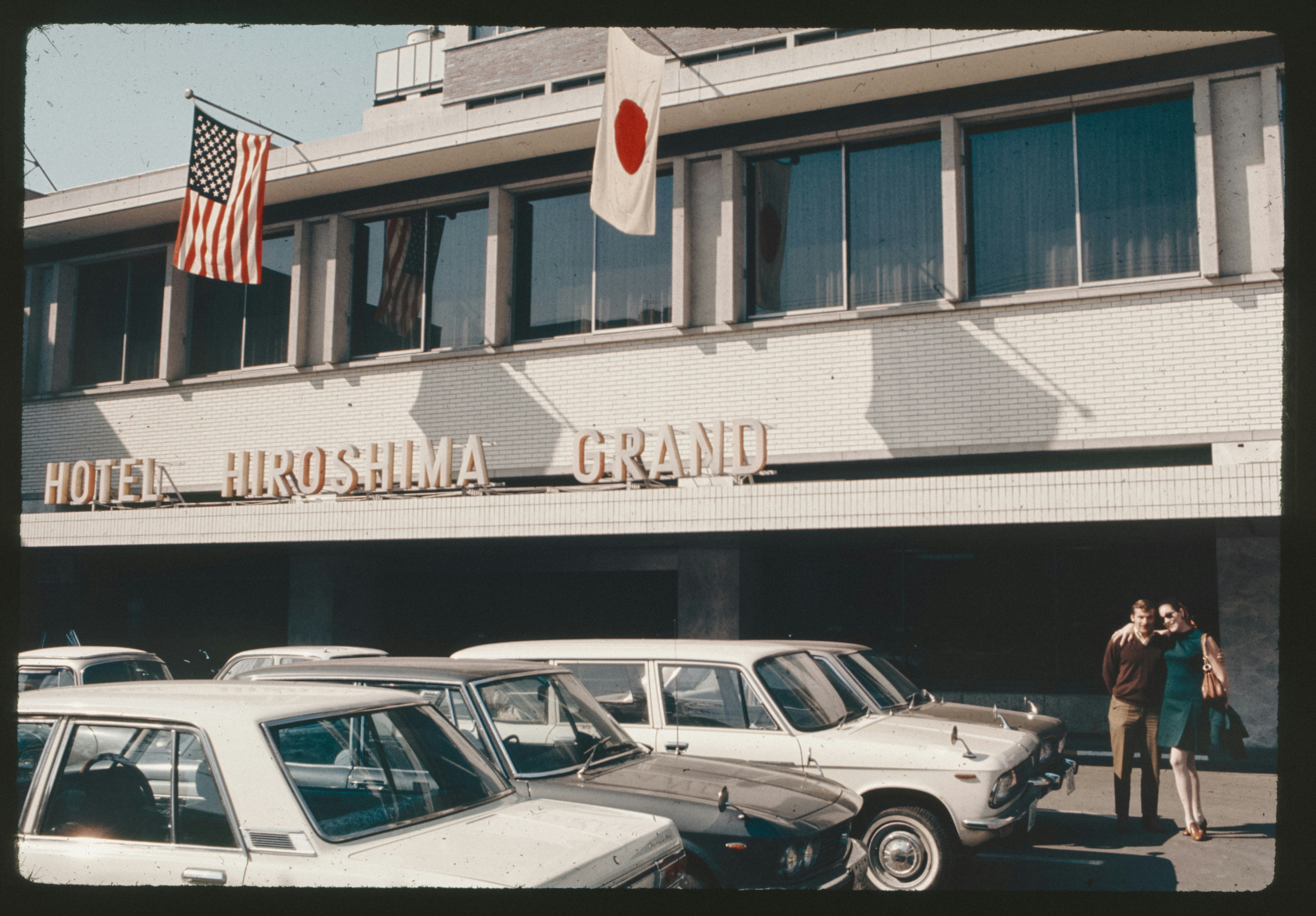 A group of cars parked in front of a hotel