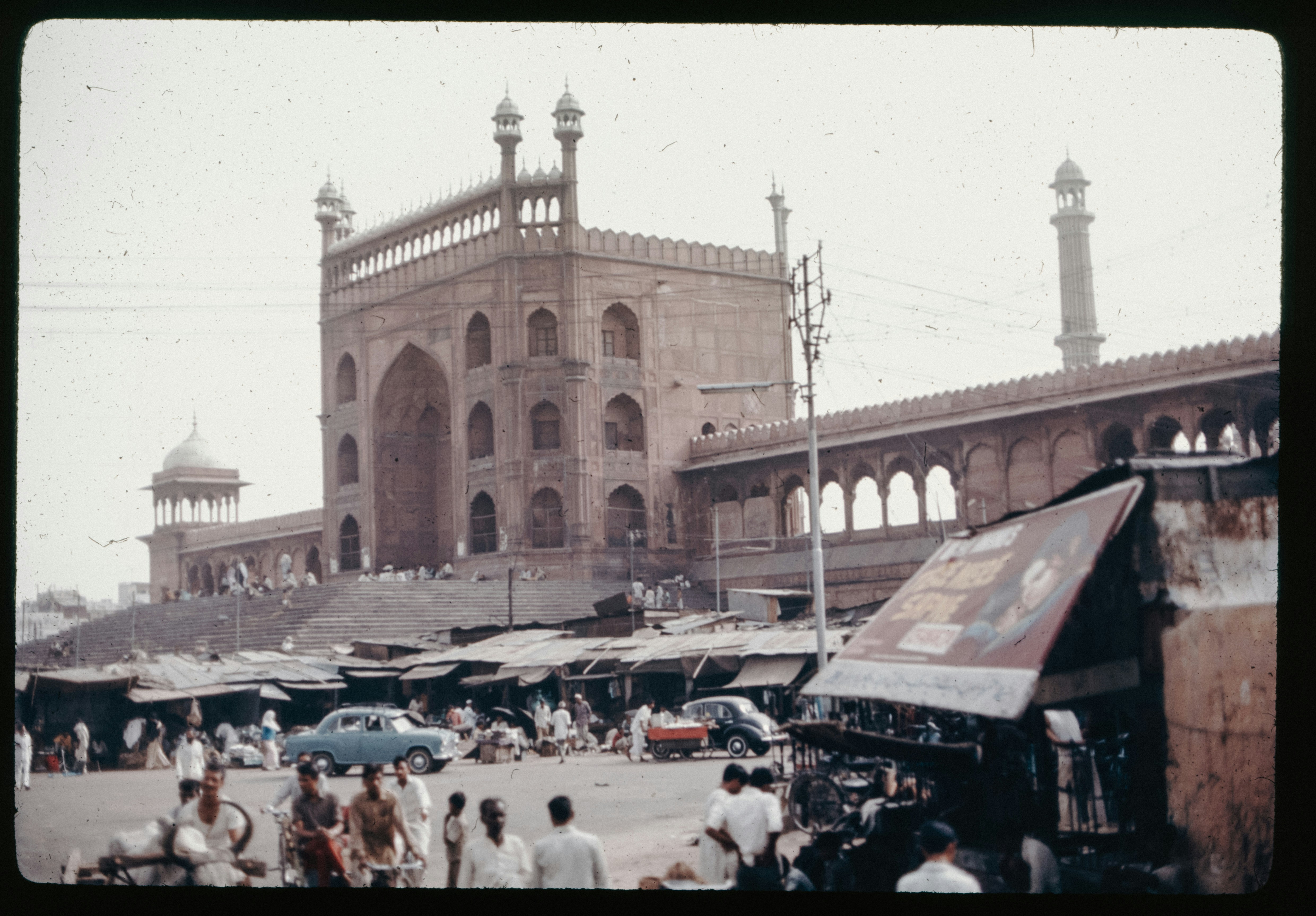 A crowd of people walking around a large building photo – Free India ...