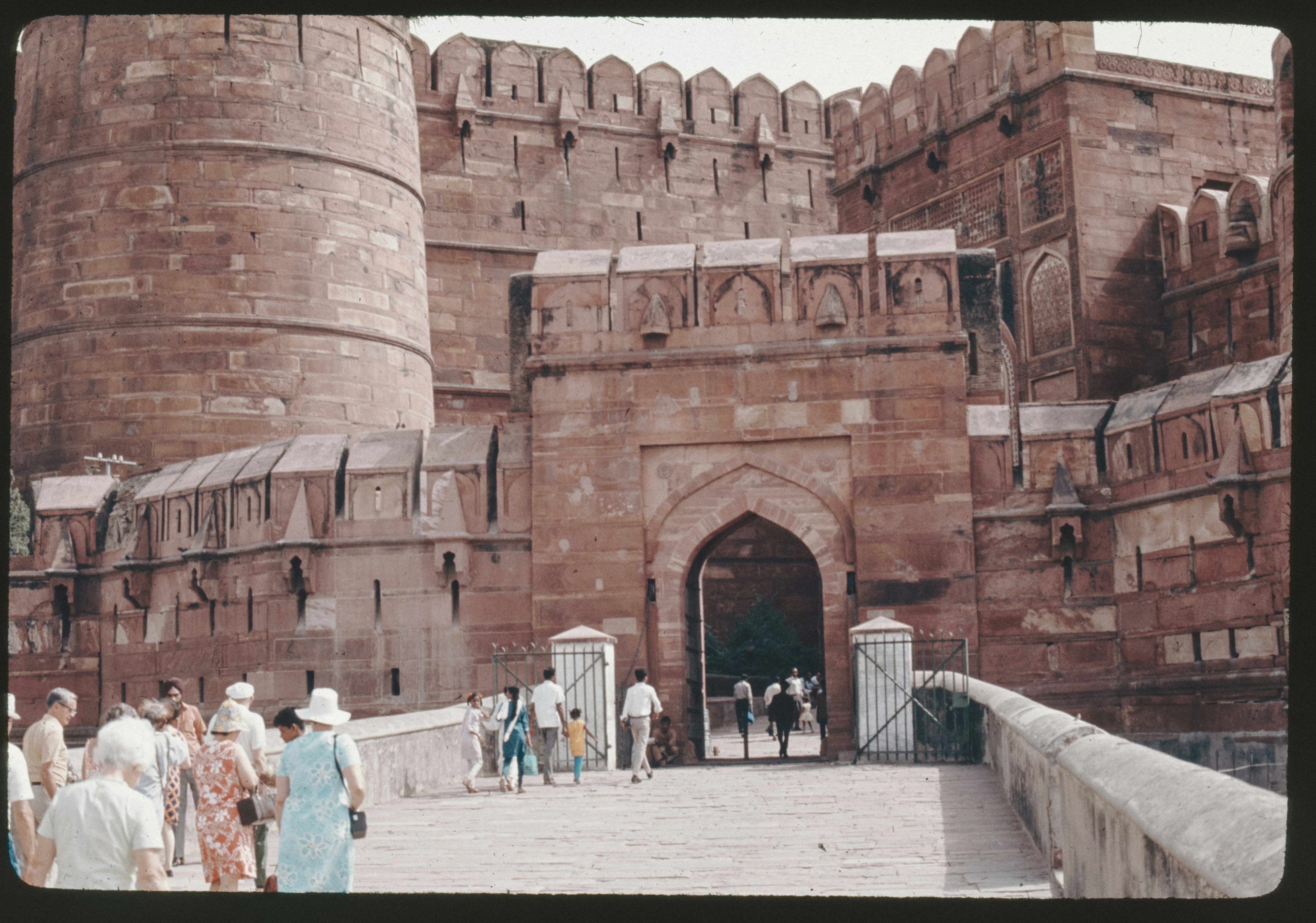 A black and white photo showing debris and uniformed personnel near a damaged structure inside the Red Fort, with a visible historical fort wall in the background.