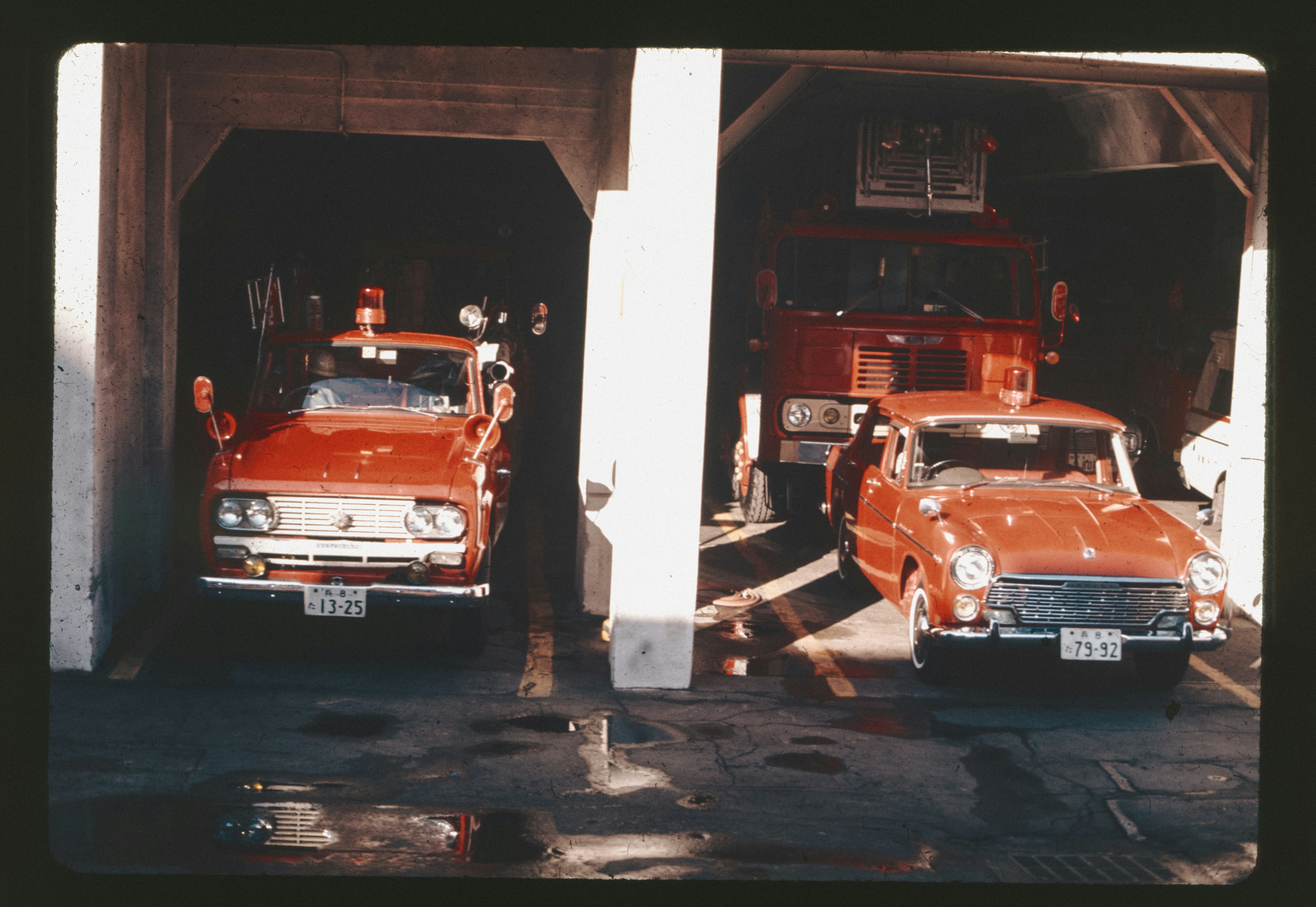 A couple of cars that are parked in a garage