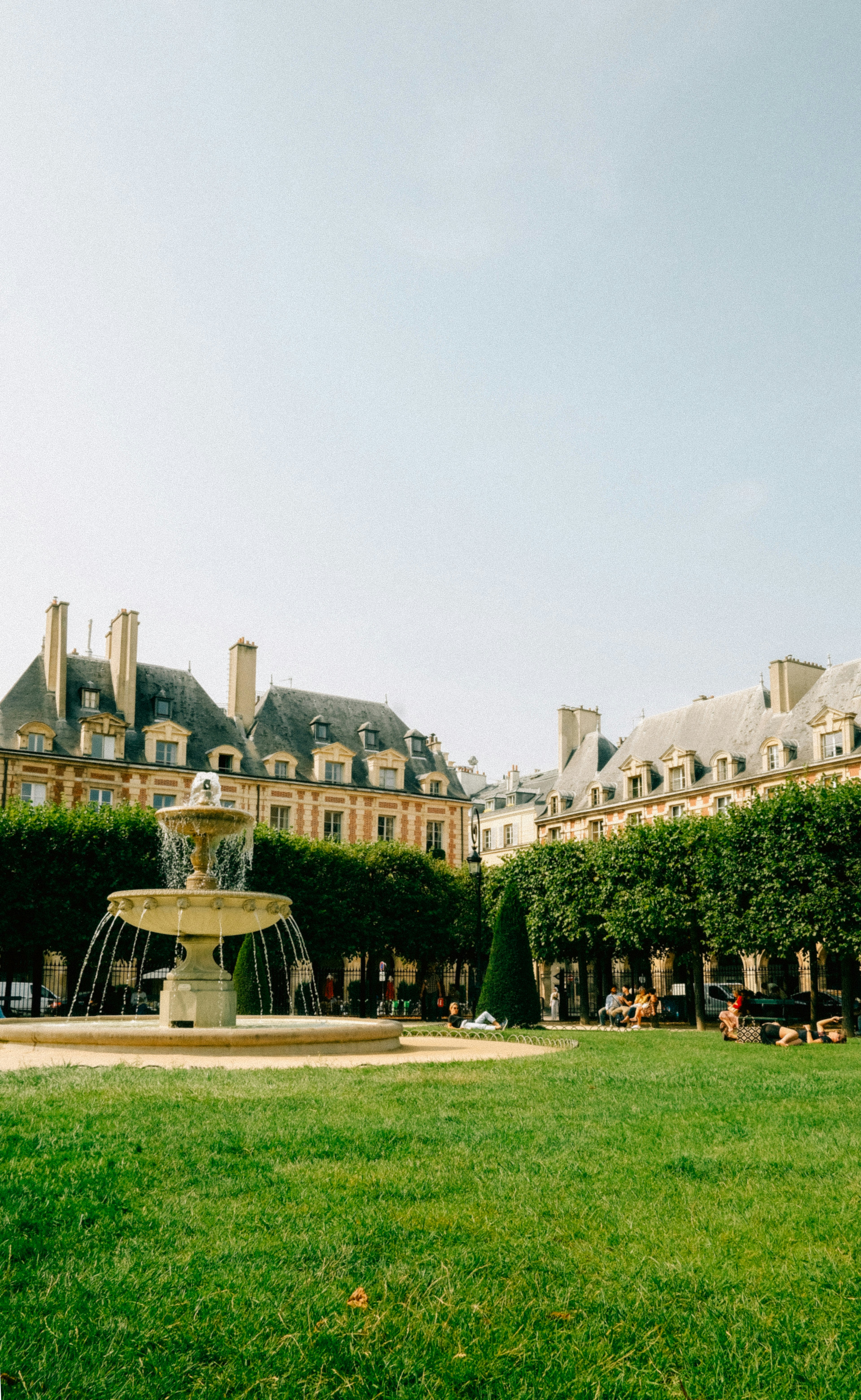 A large building with a fountain in front of it
