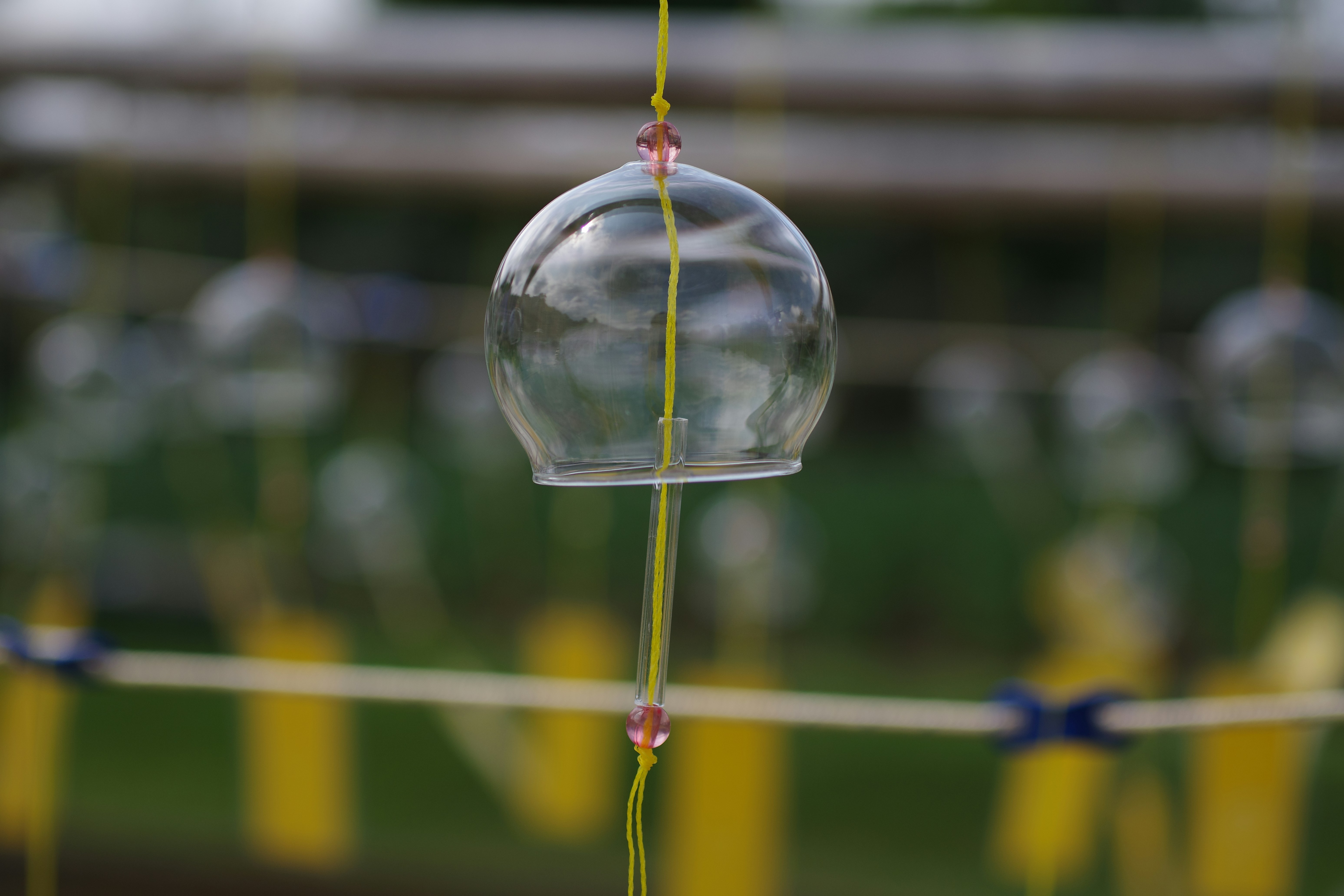 A wind chime hanging from a rope in a park photo – Free Outdoors Image ...