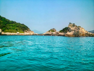 A body of water that has some rocks in it