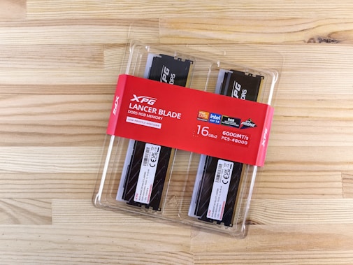A couple of black and white knives in a package