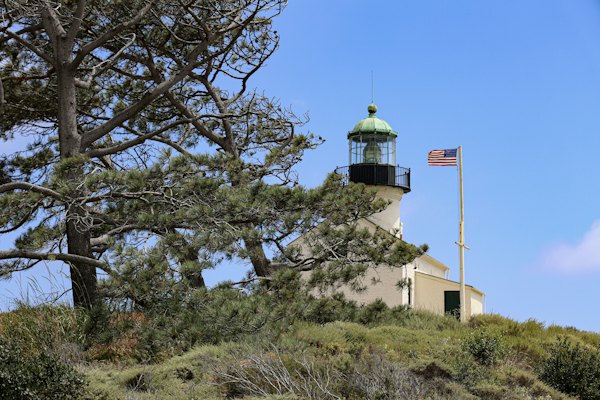 A lighthouse on top of a hill with trees — San Diego, United States