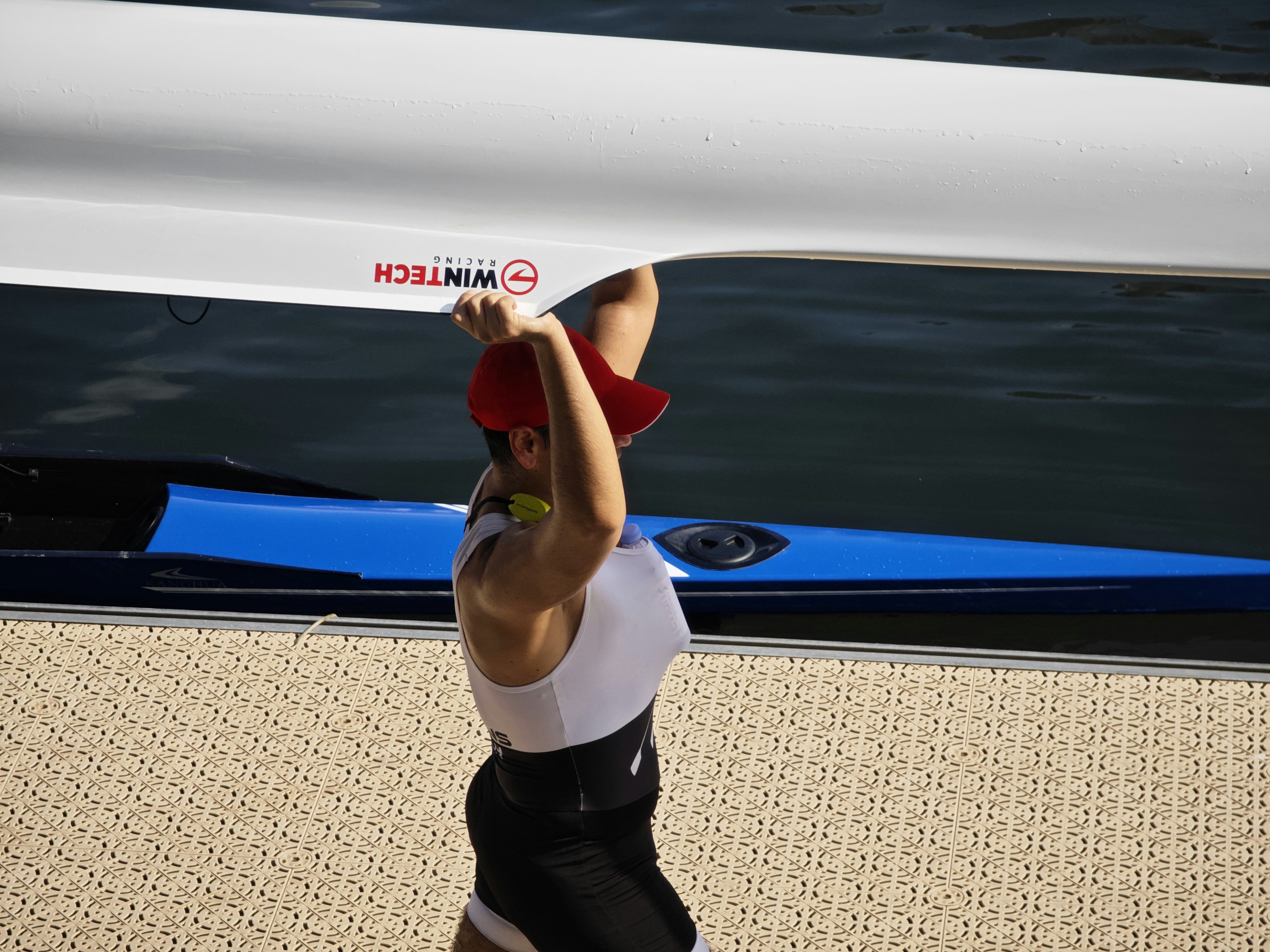 A man holding a surfboard over his head