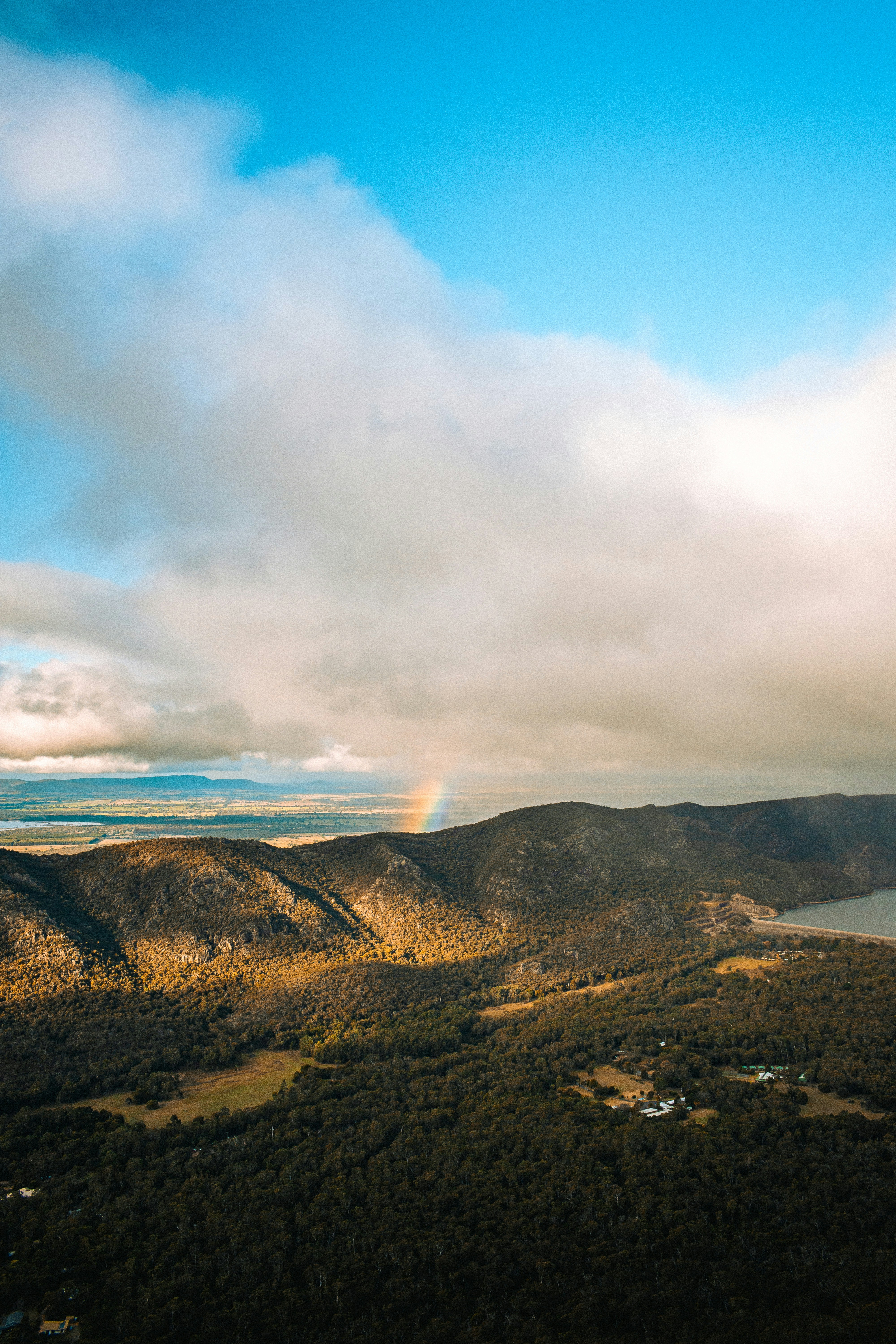 A rainbow in the sky over a mountain range
