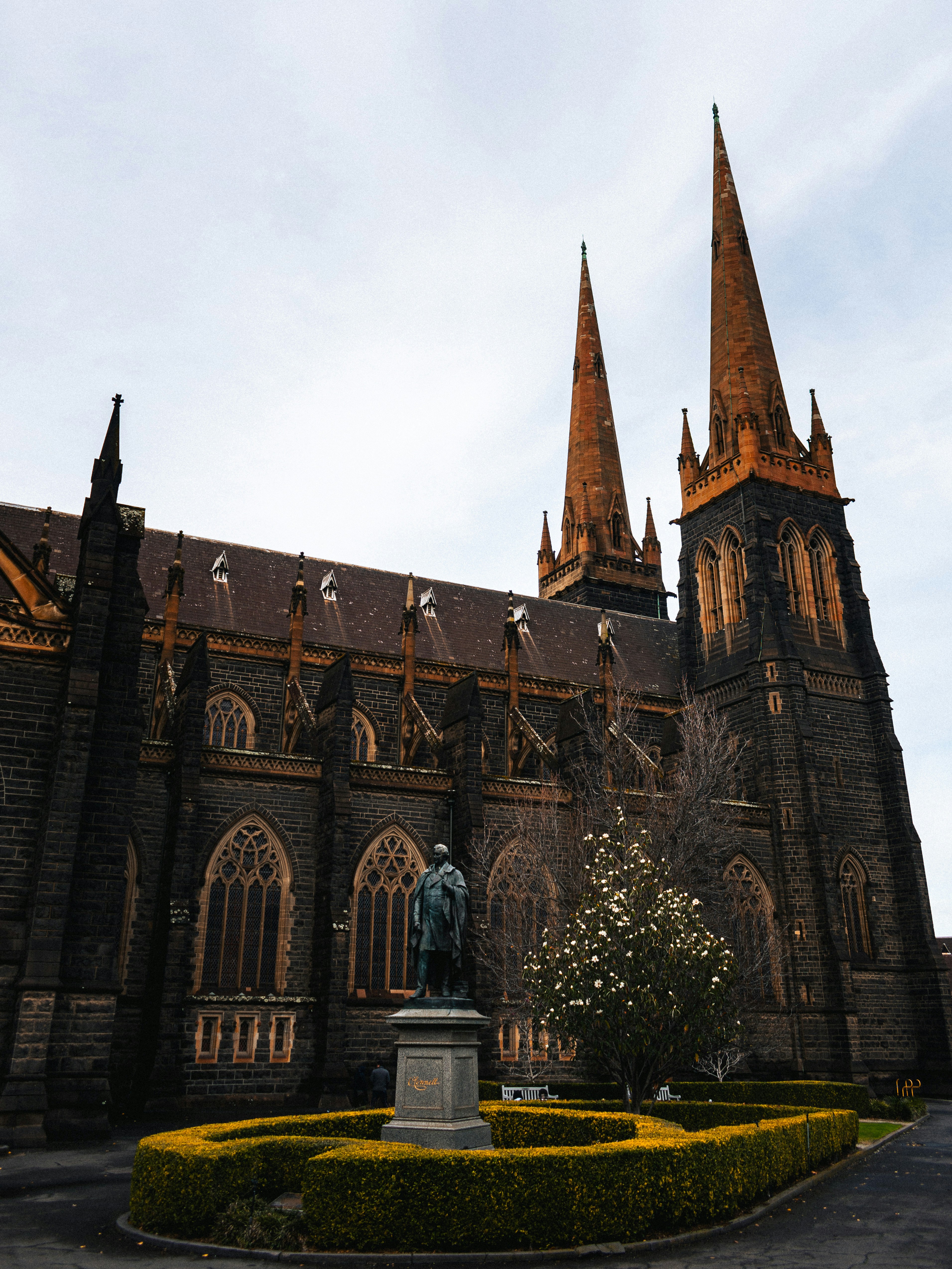 A large church with a statue in front of it