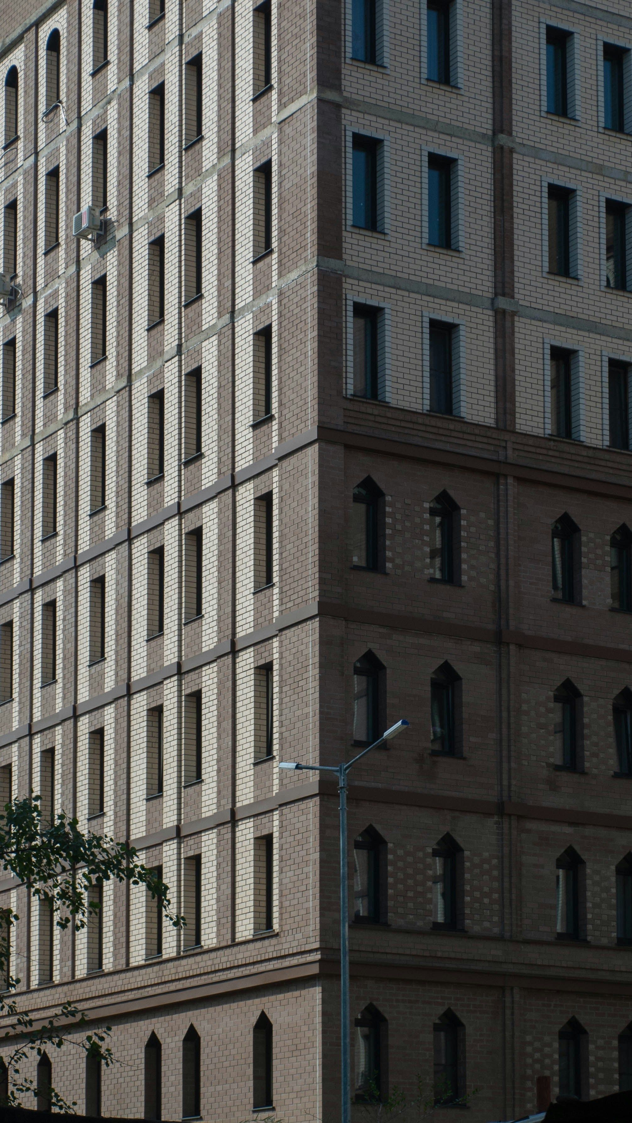 Un grand immeuble assis à côté d’un feu de circulation