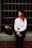 A woman with red hair sitting on a step