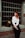 A woman with red hair sitting on a window sill