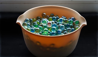 A bowl filled with balls sitting on top of a stove