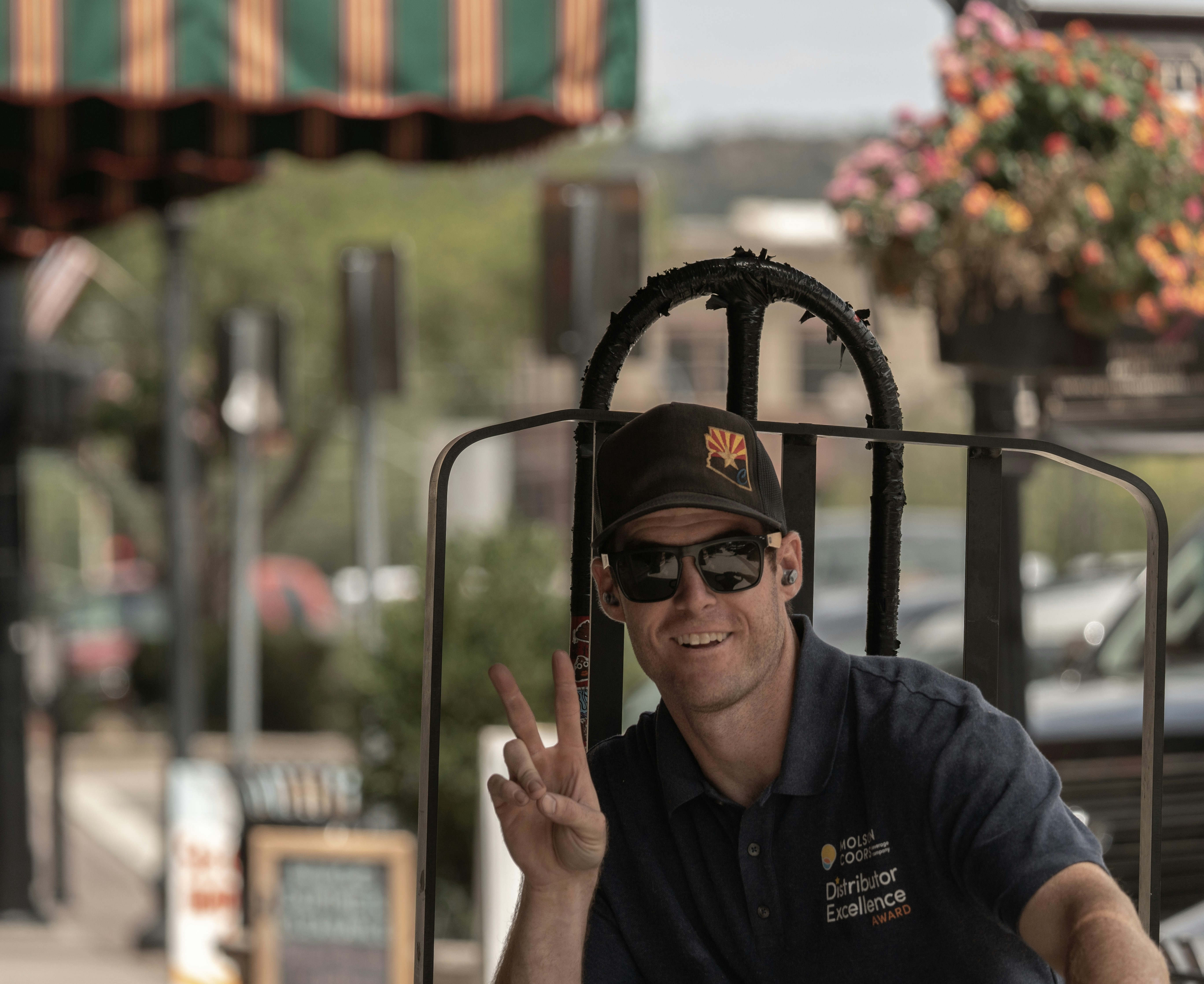 A man sitting in a chair making a peace sign