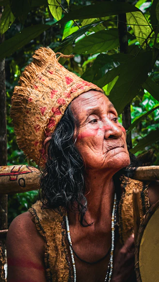 An old woman with a drum in her hand