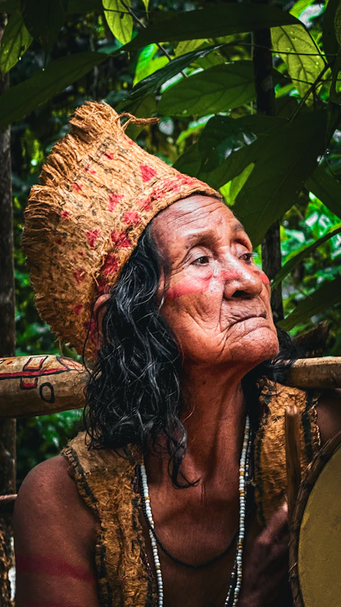 An old woman with a drum in her hand