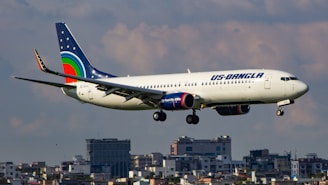 A large passenger jet flying over a city