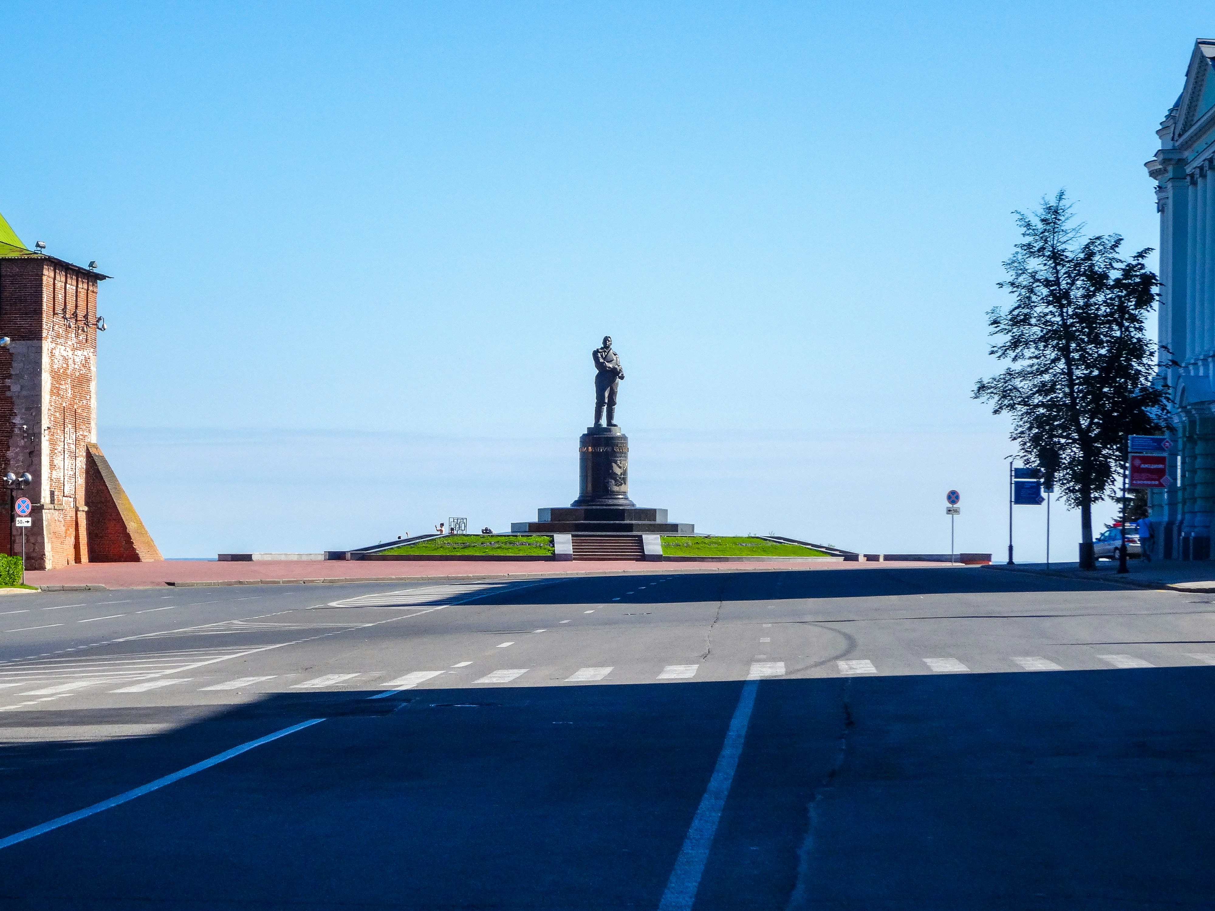 An empty street with a statue in the middle of it