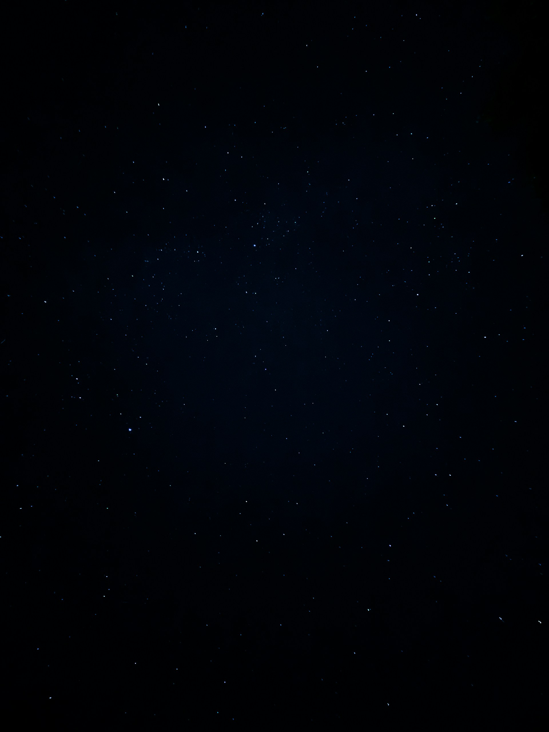A night sky with stars and the moon