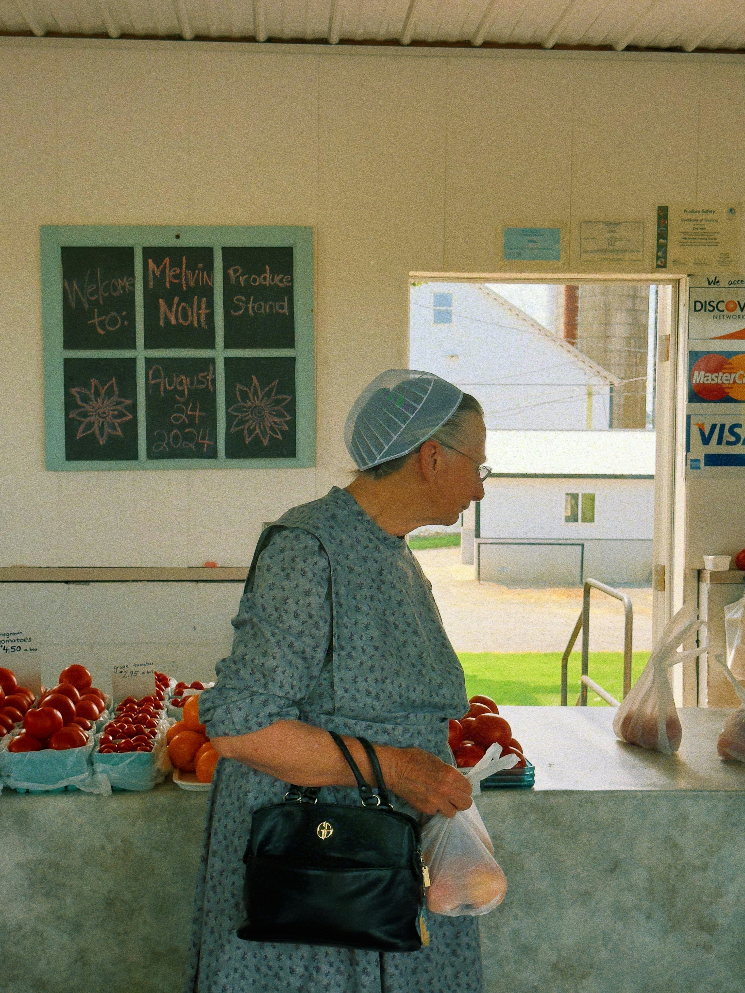 A woman standing in front of a fruit stand photo – Free Portrait Image ...