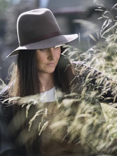 A woman in a hat looking at her cell phone
