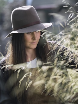A woman in a hat looking at her cell phone