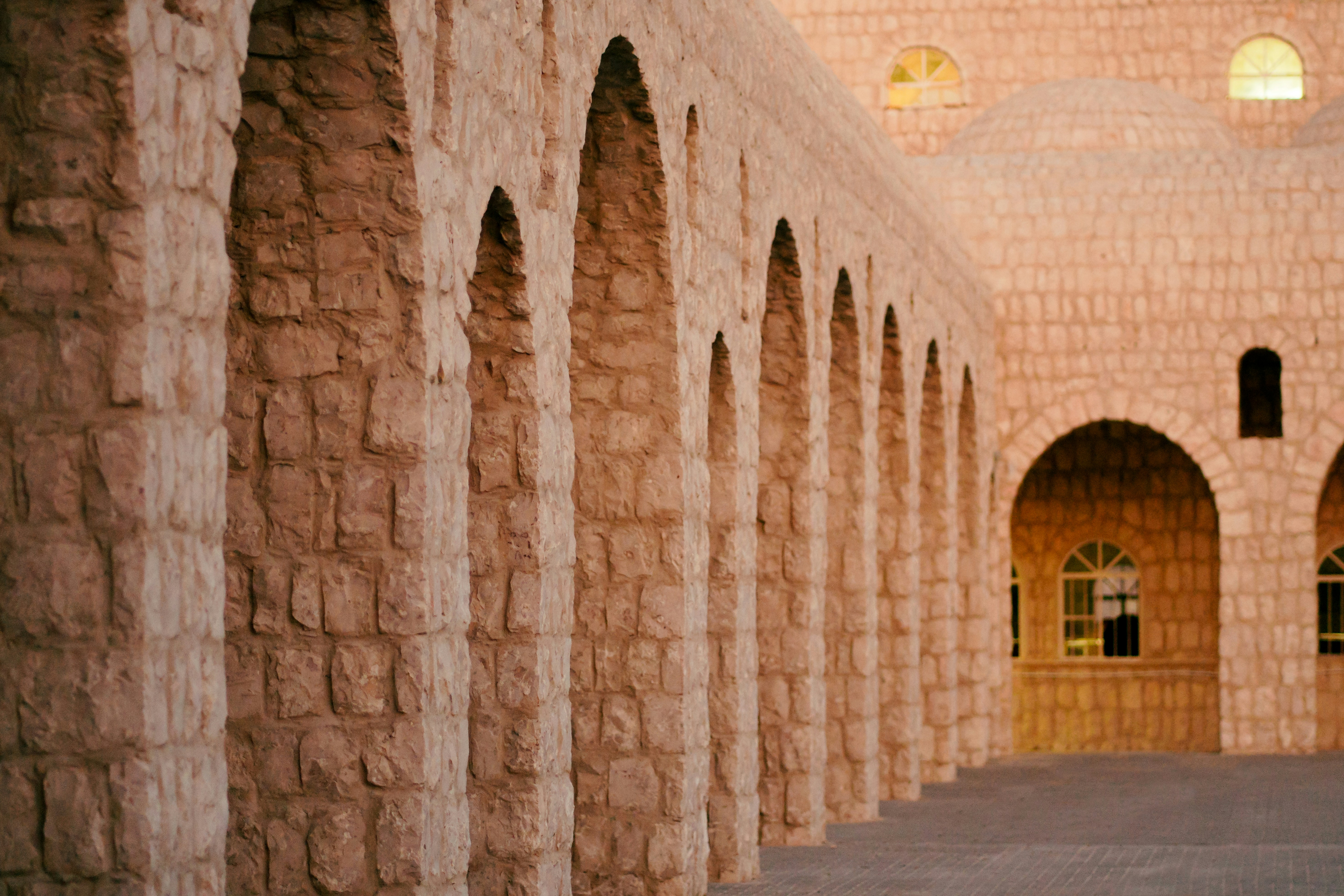 A large room with a row of stone pillars