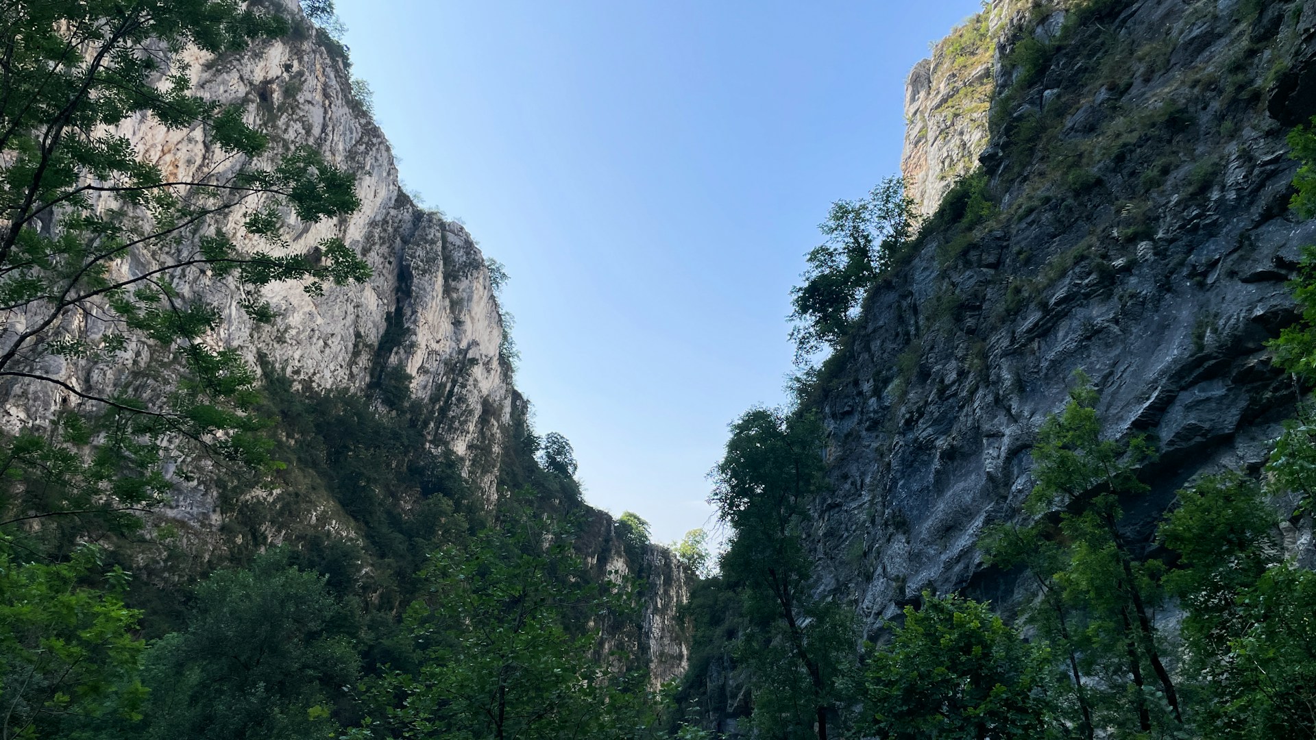 A narrow river with a mountain in the background