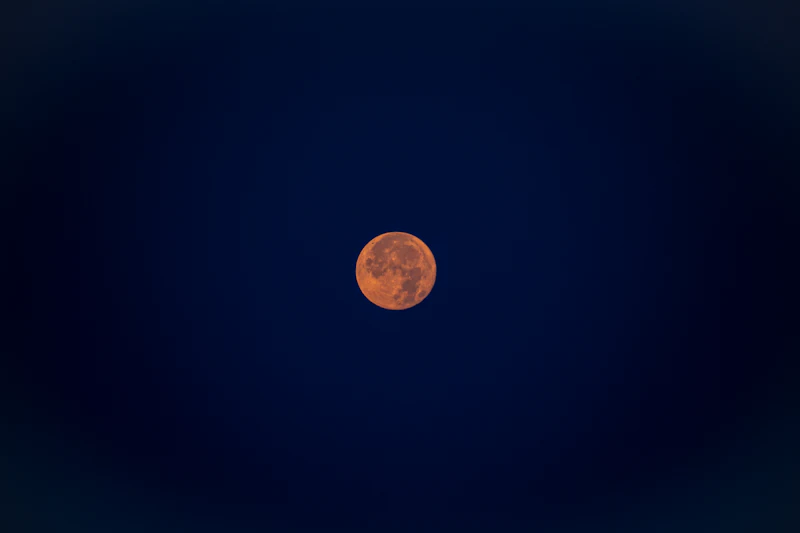 A full moon in a dark night sky