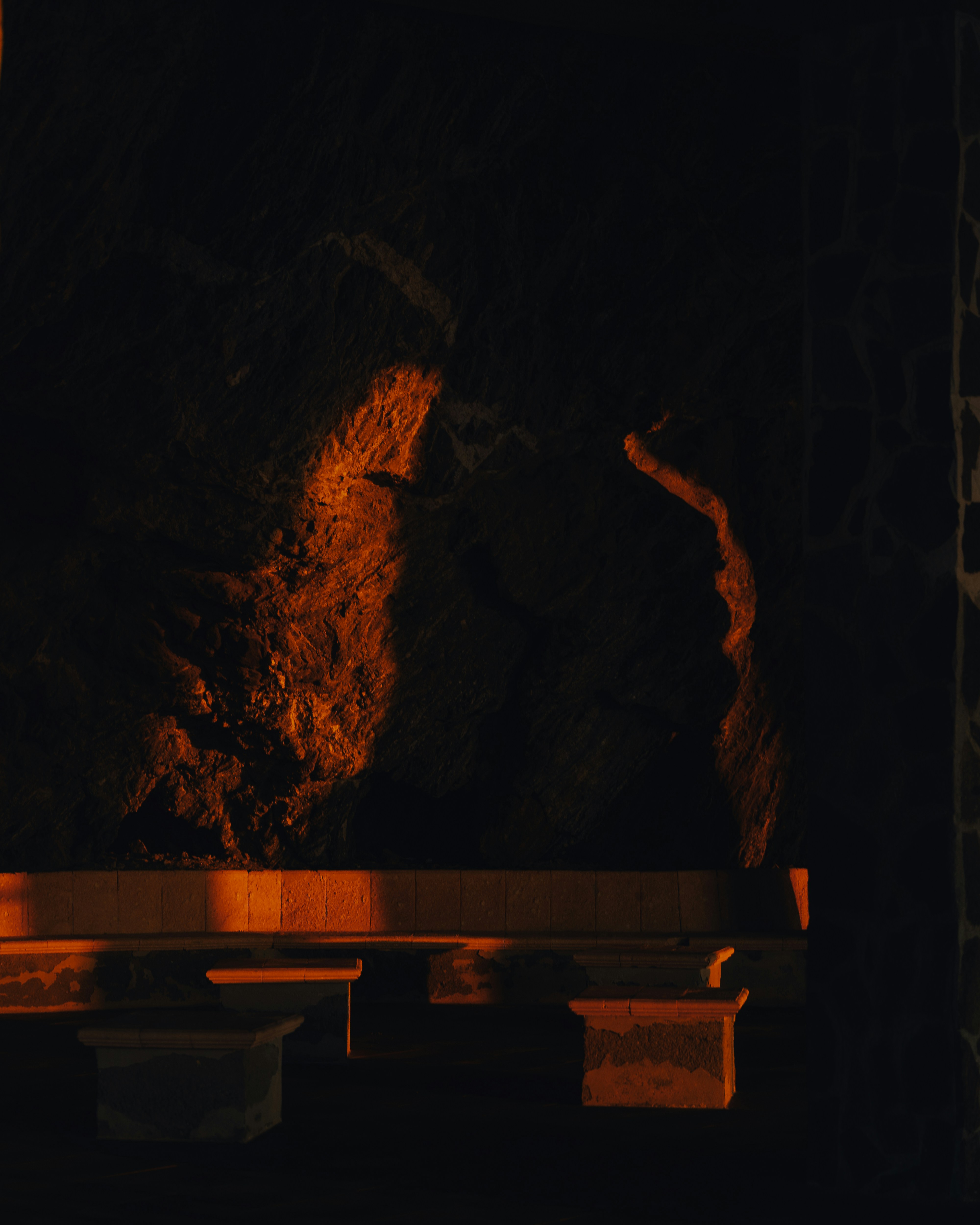 A bench sitting in front of a fire place