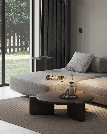 A living room with a couch, coffee table and sliding glass doors