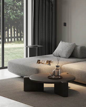 A living room with a couch, coffee table and sliding glass doors