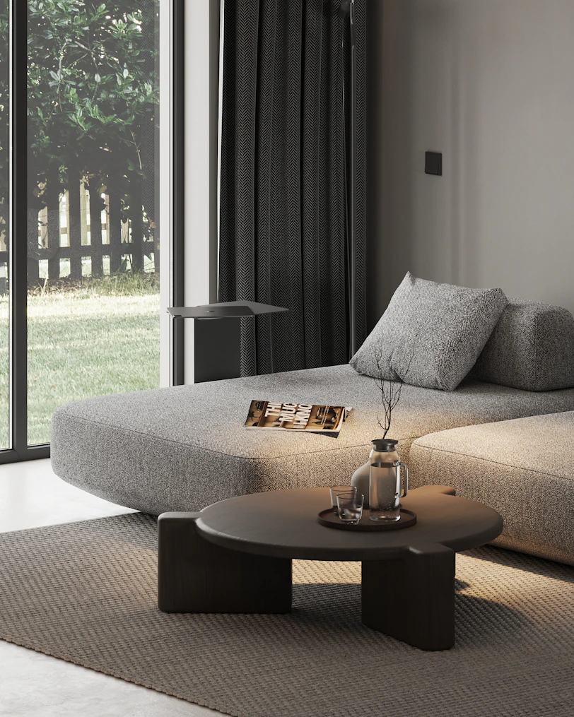 A living room with a couch, coffee table and sliding glass doors