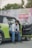 A man sitting in the back of a green car