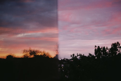 A picture of a sunset taken through a window