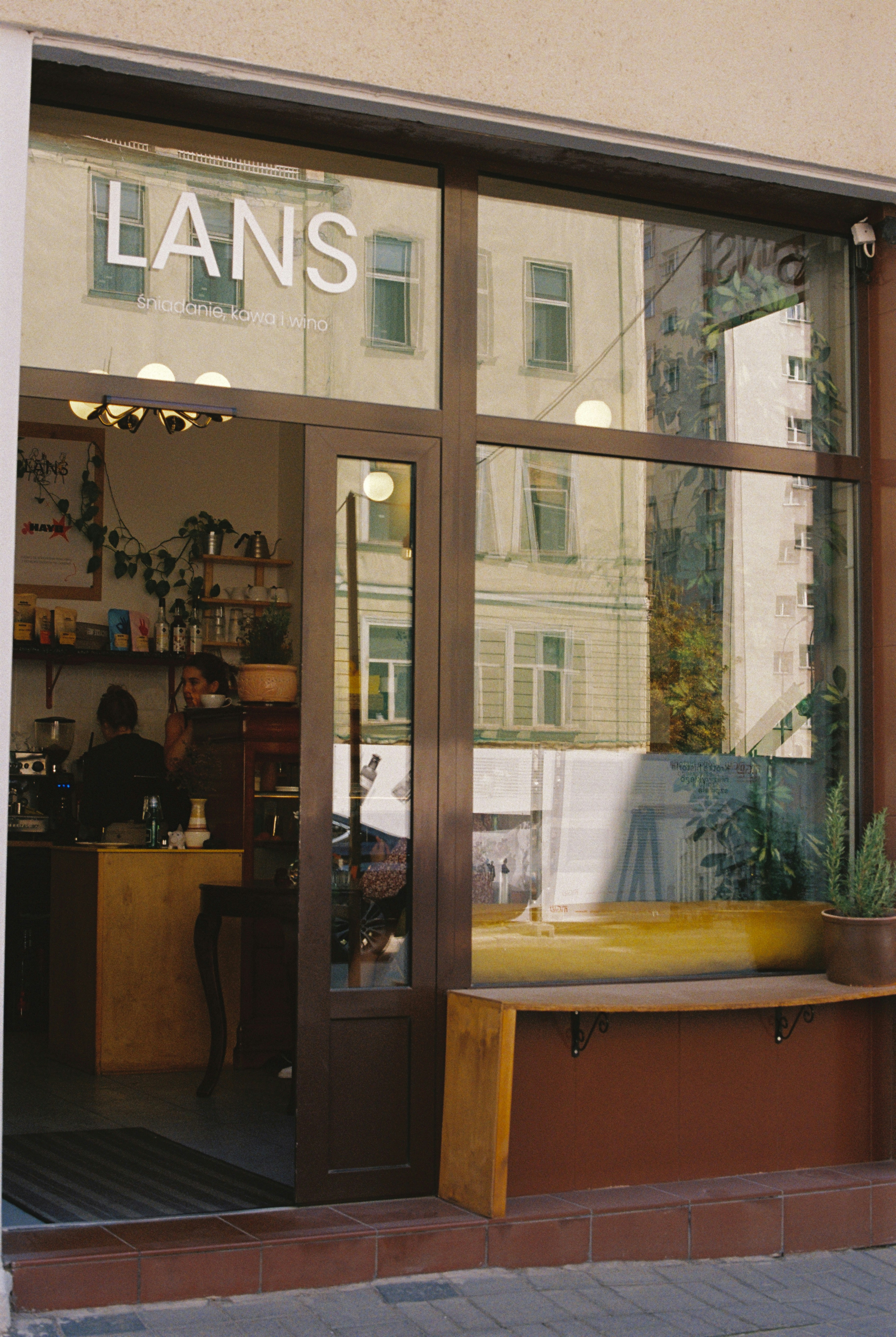A store front with a yellow bench in front of it photo – Free Travel ...