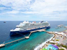 A cruise ship docked at a pier in the ocean