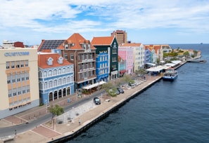 A large body of water next to a row of buildings
