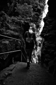 A woman with a backpack walking up a set of stairs
