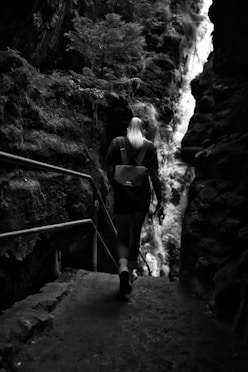 A woman with a backpack walking up a set of stairs