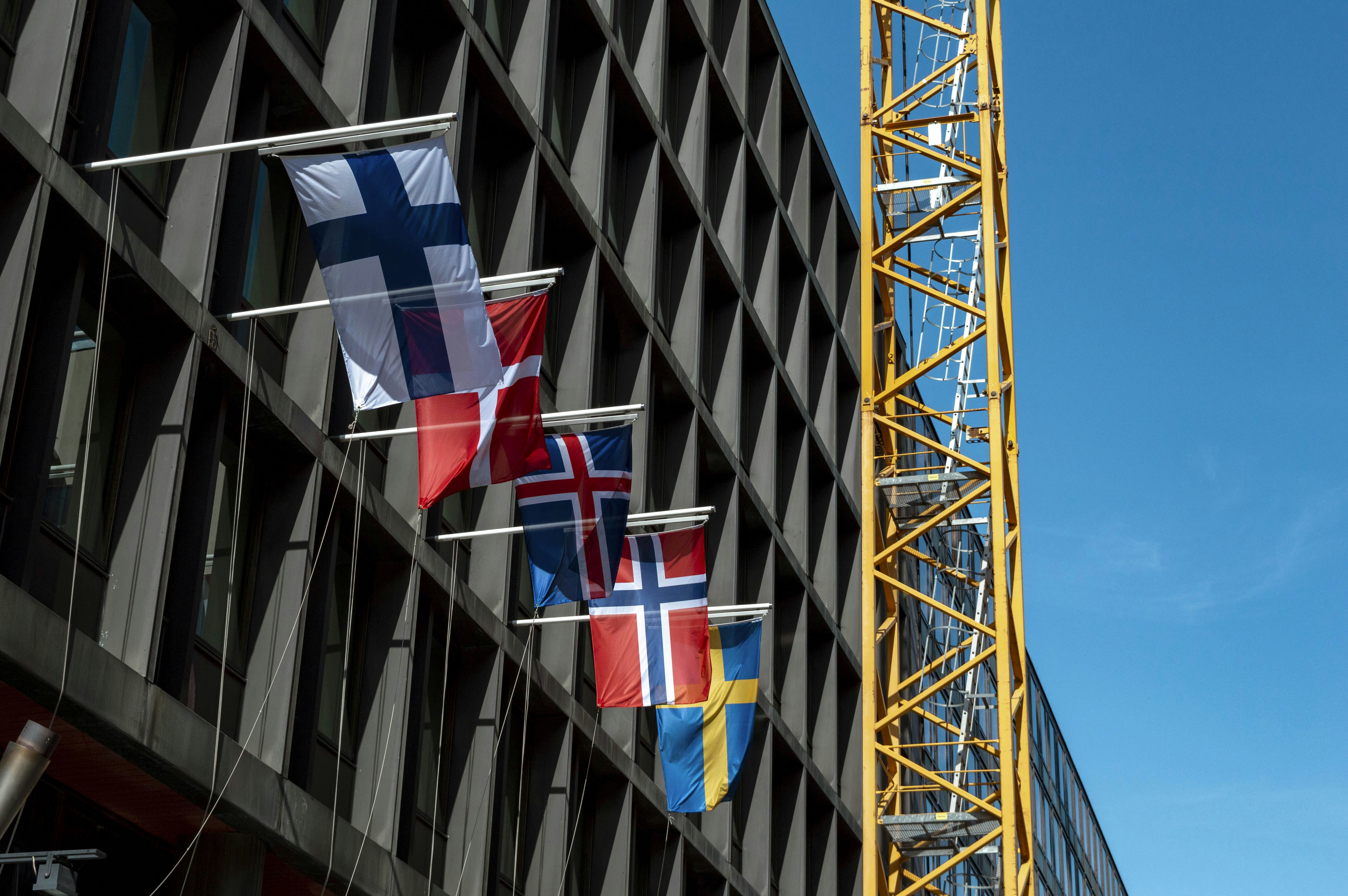A tall building with a crane next to it