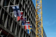A tall building with a crane next to it