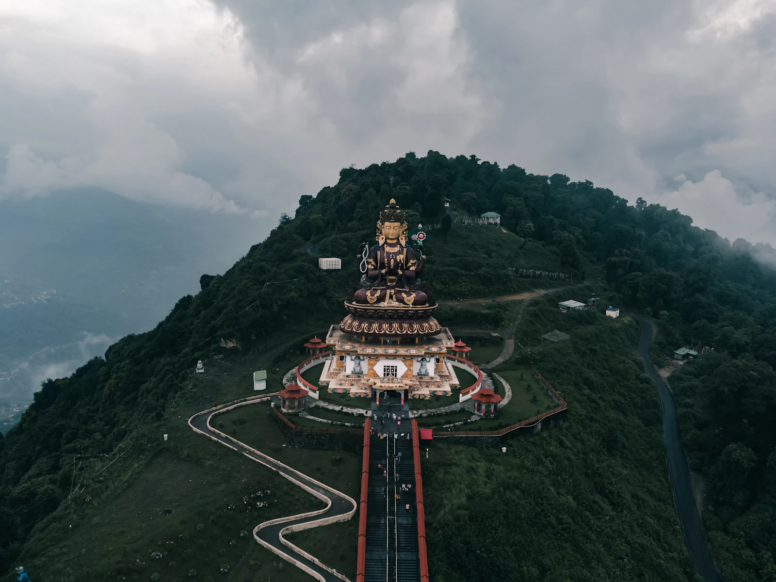 The Chenrezig statue on its hilltop above Pelling, the skywalk path climbing to it through drifting cloud