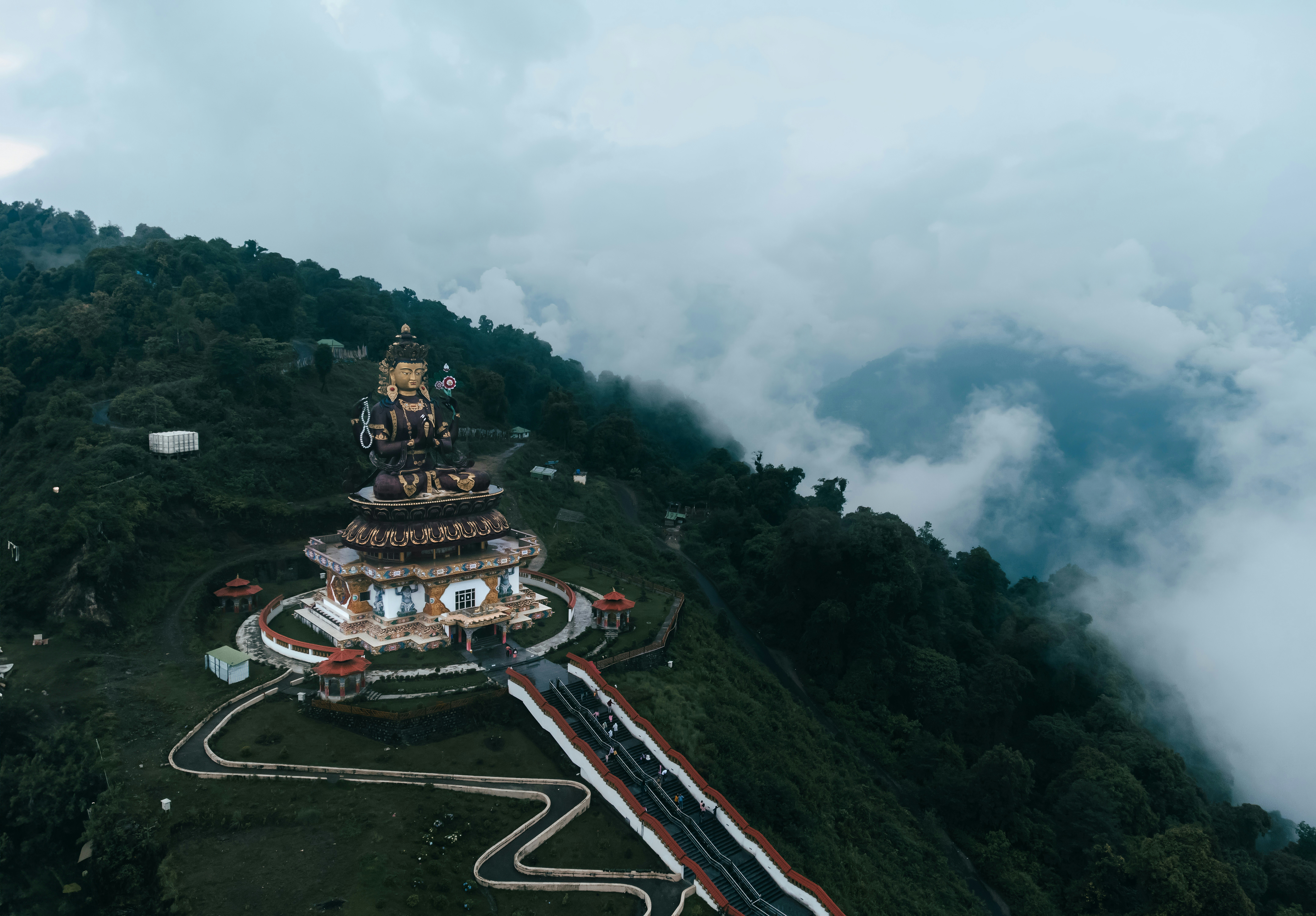 An aerial view of a mountain with a pagoda on top