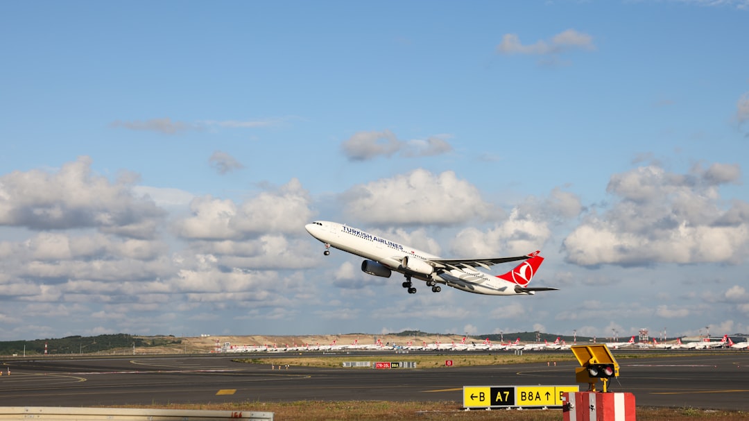 A large jetliner flying through a blue cloudy sky, Turkish Airlines Airbus A330-300 soaring against a backdrop of delica