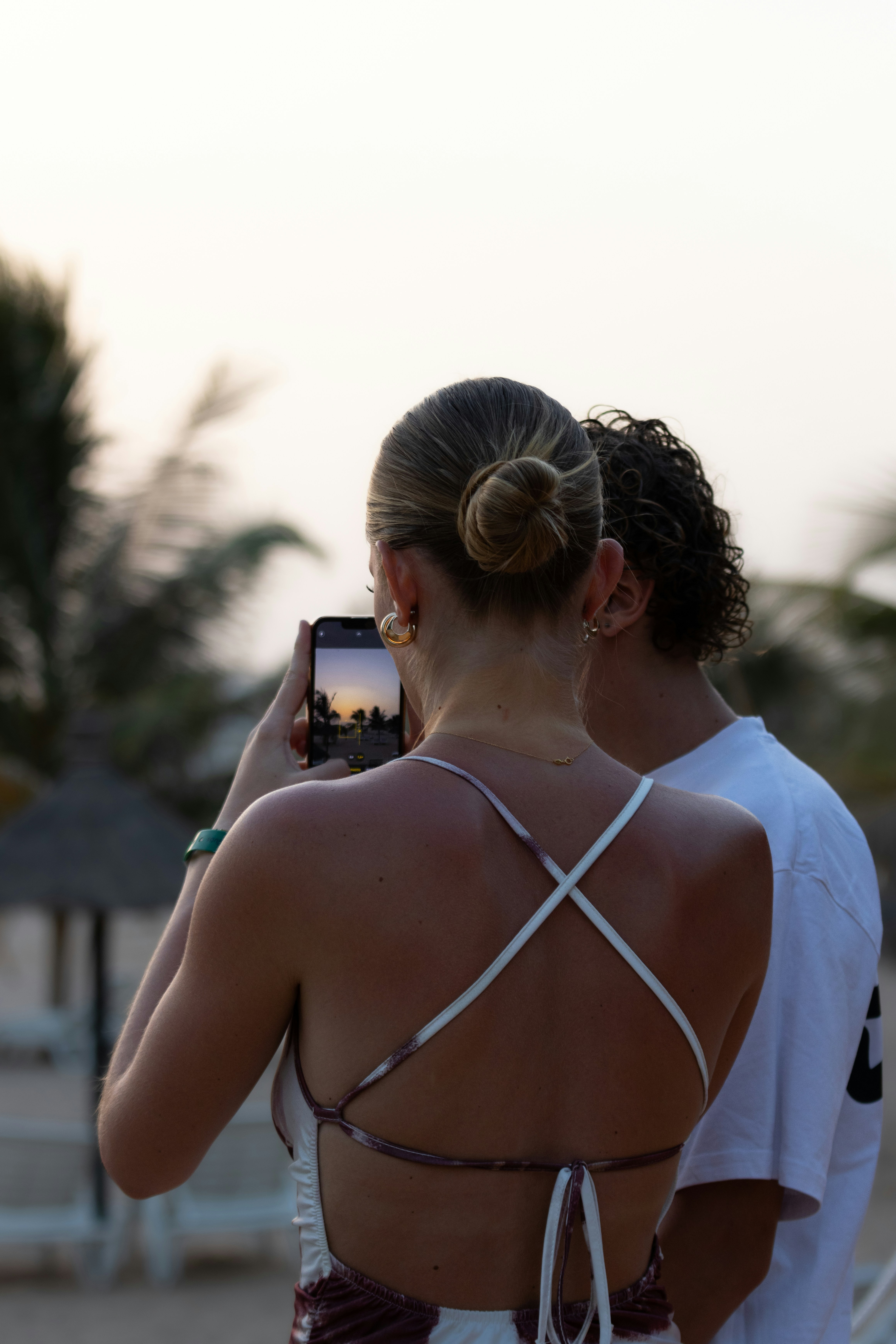 A woman is taking a picture of herself on the beach