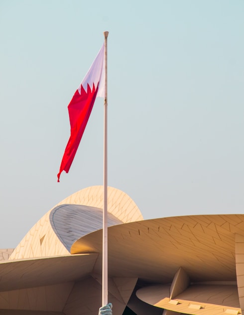 A flag is flying in front of a building