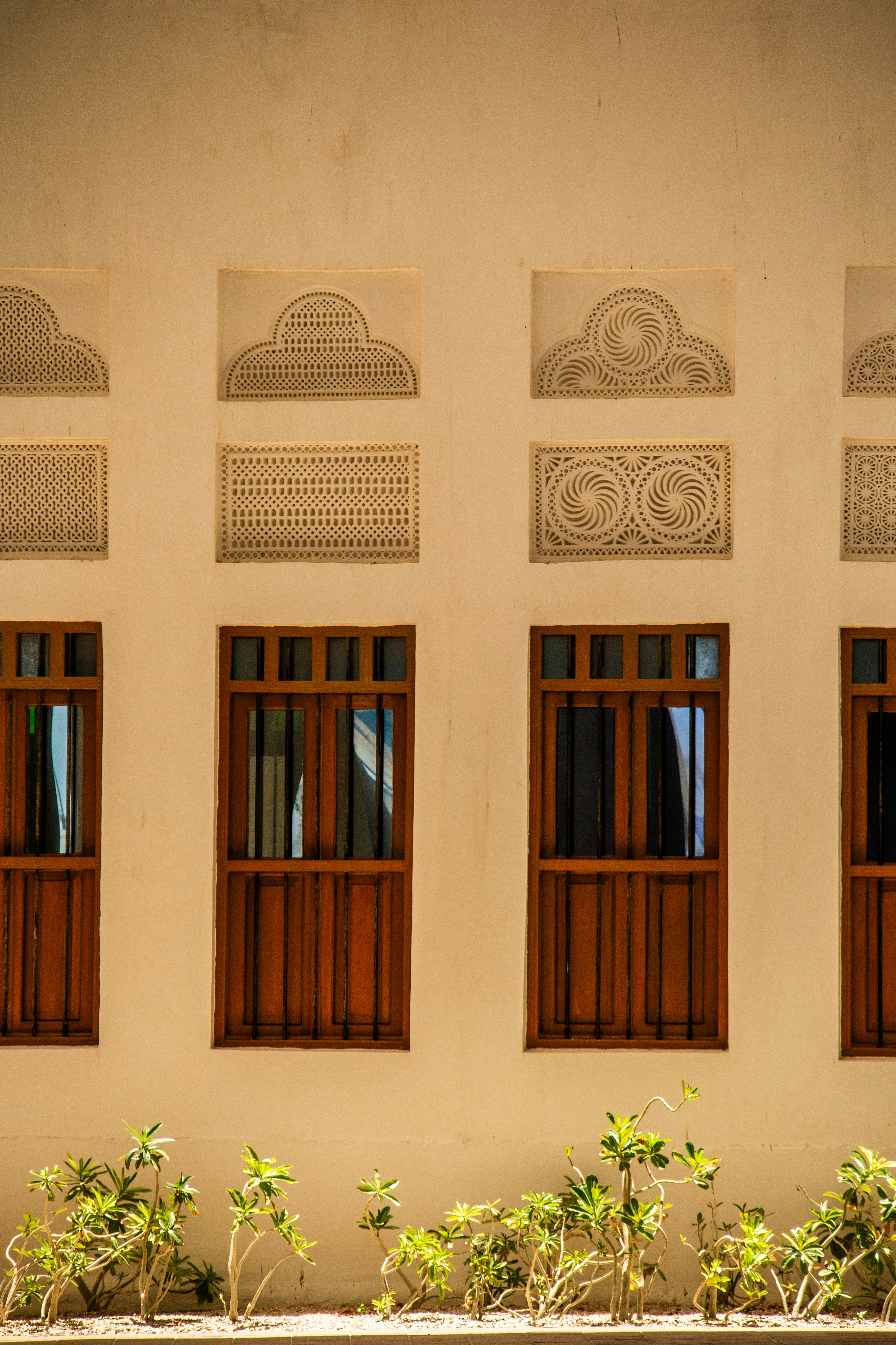 A bench sitting in front of a white building