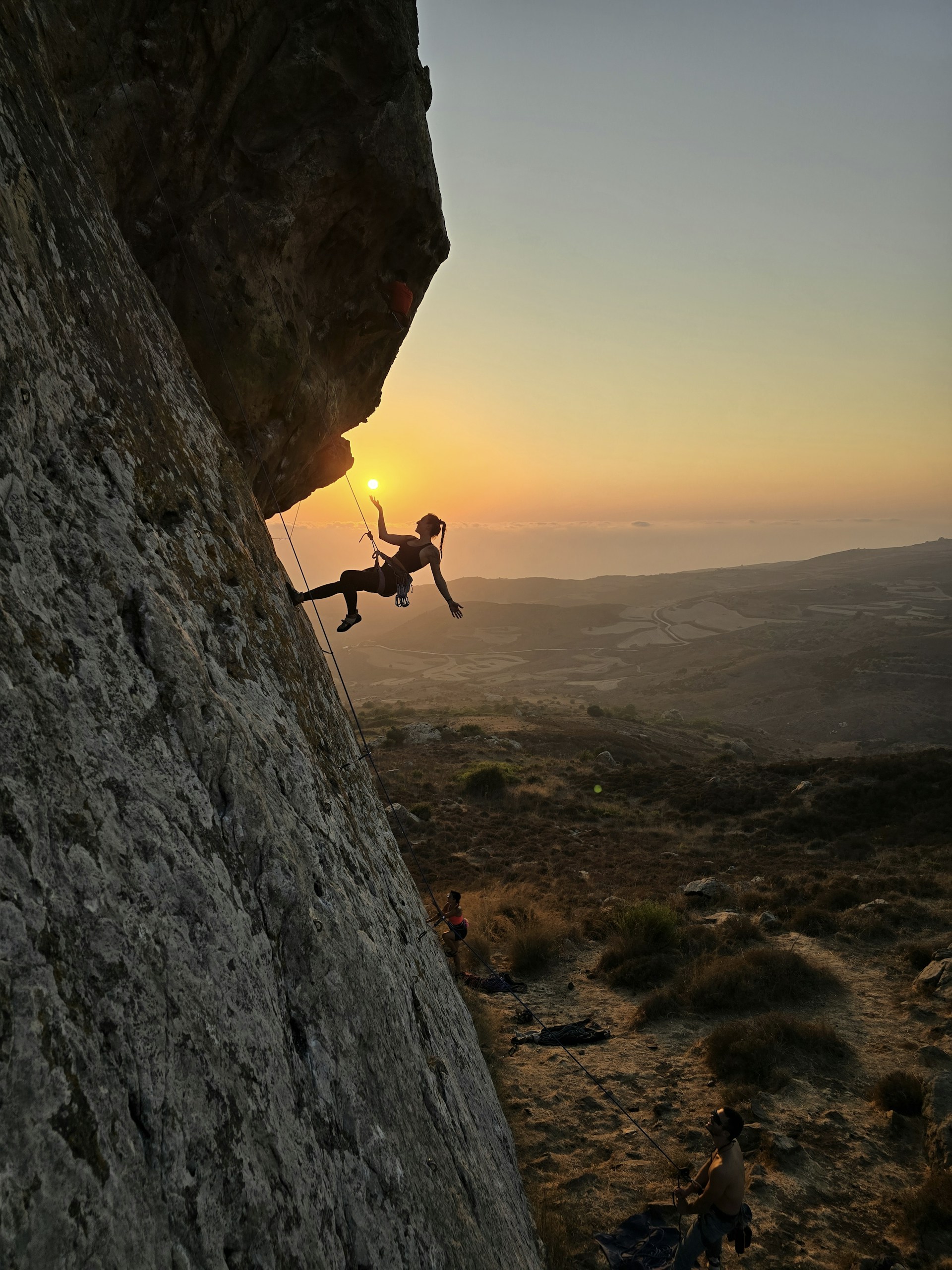 A man climbing up the side of a mountain